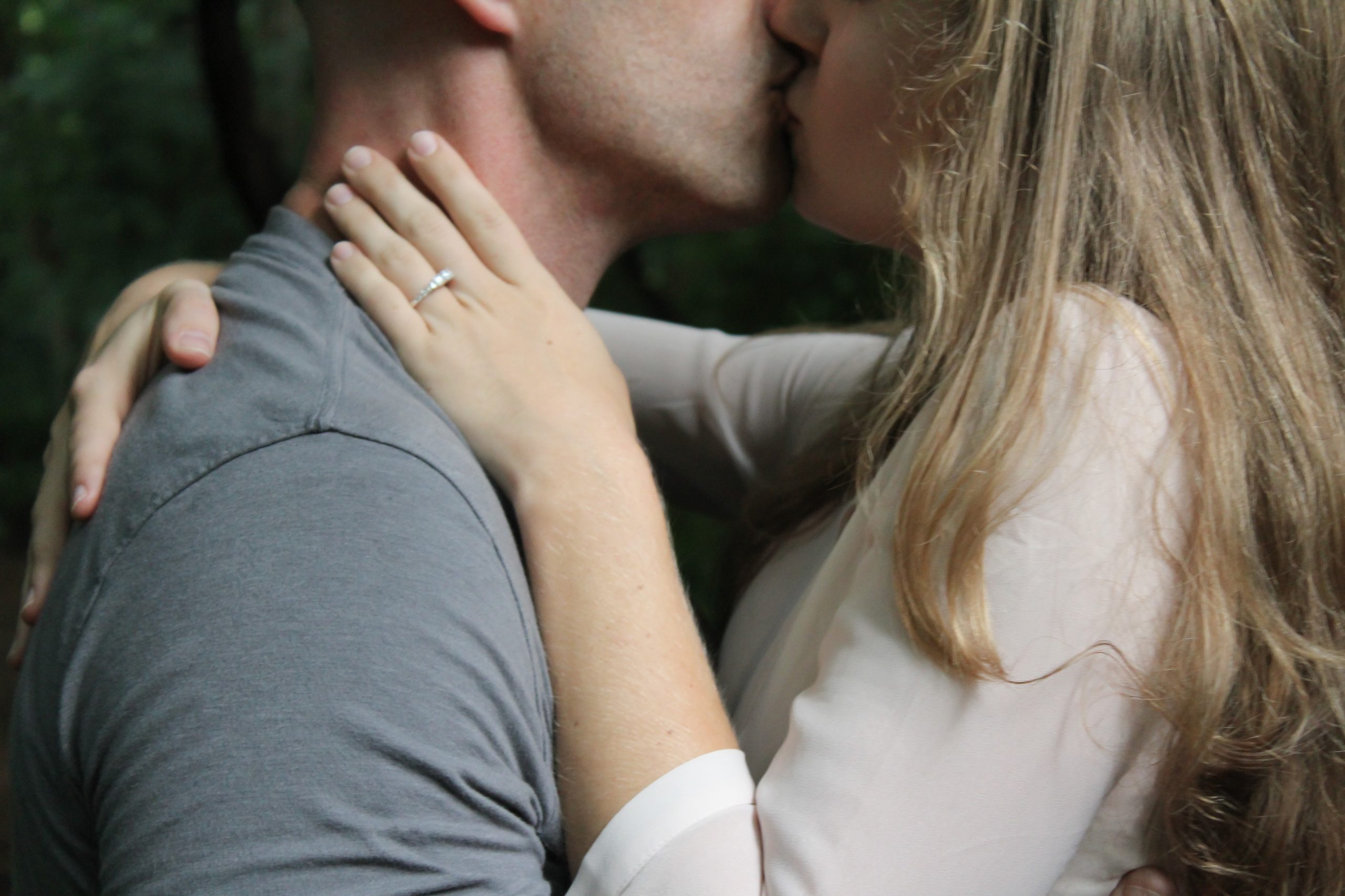 A close-up image of man and woman kissing