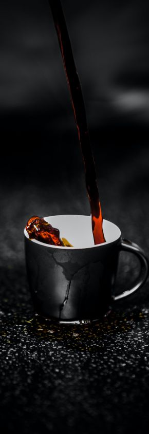Brown Liquid Pouring on Black and White Ceramic Mug Selective Color Photography