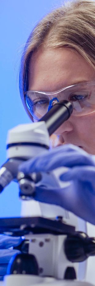 Illustration of a close-up view of a researcher studying a microscope slide