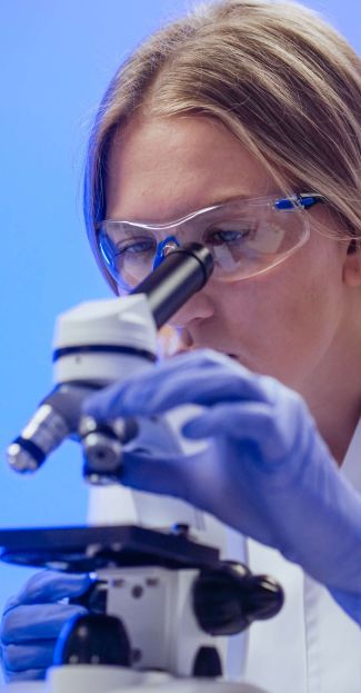 Illustration of a close-up view of a researcher studying a microscope slide
